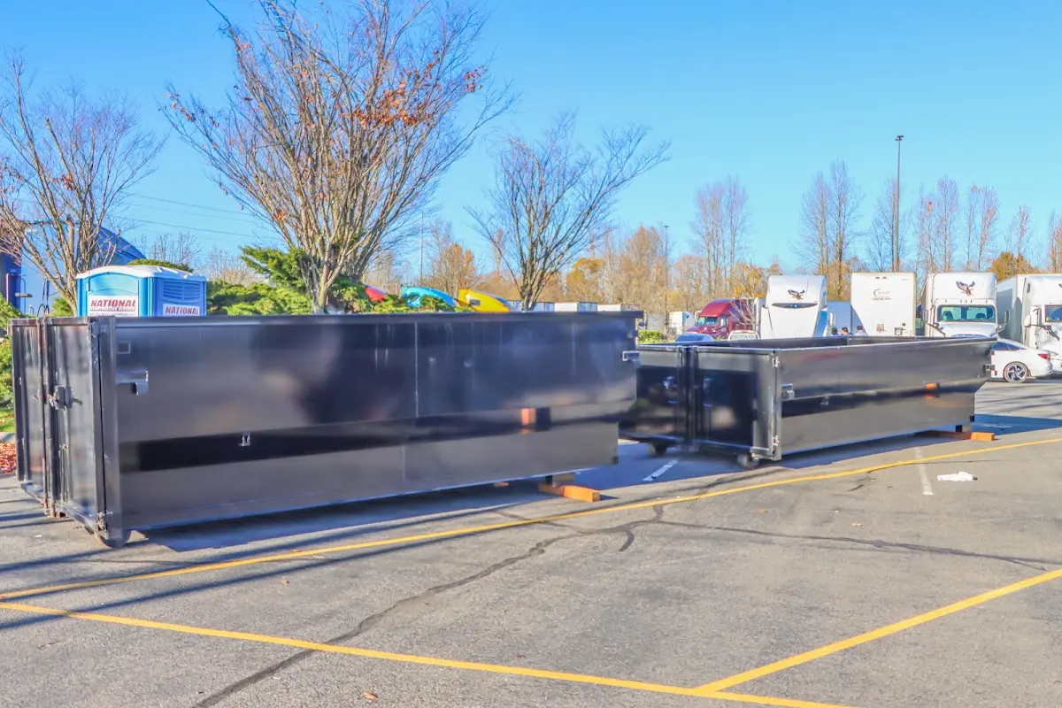 Professional dumpster rental service with roll-off container on residential driveway in Palm Beach